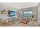 Bright and airy living room with sliding glass doors leading to a patio at 10434 Spring Tide Way, Parrish, FL 34219