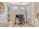 Home office with window, desk, chair, and built-in shelving at 10434 Spring Tide Way, Parrish, FL 34219