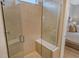 Walk-in shower with glass enclosure and built-in seat at 10434 Spring Tide Way, Parrish, FL 34219