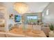 Open concept living room with large TV, comfortable seating, and access to the patio at 10434 Spring Tide Way, Parrish, FL 34219