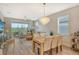 Light and bright dining room with wood table, seating for six, and access to back patio at 10434 Spring Tide Way, Parrish, FL 34219