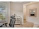 Home office with window, white cabinet, and view of hallway at 10434 Spring Tide Way, Parrish, FL 34219