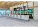 Outdoor bar with multiple TVs and seating, overlooking a lake at 10434 Spring Tide Way, Parrish, FL 34219