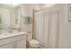 Clean bathroom with white vanity, shower/tub combo, and updated fixtures at 10434 Spring Tide Way, Parrish, FL 34219