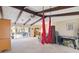 Relaxing living room featuring exposed beams, sliding doors and red hang chairs at 4607 Masefield Pl, Sarasota, FL 34241