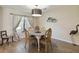 Bright dining room with a table and four gold chairs, and decorative wall art at 4607 Masefield Pl, Sarasota, FL 34241