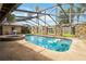 Screened pool area with spa and stone accents at 4607 Masefield Pl, Sarasota, FL 34241