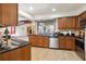 Kitchen with wood cabinets, granite counters, and stainless steel appliances at 4607 Masefield Pl, Sarasota, FL 34241
