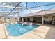 Large screened-in pool with a spa and surrounding patio at 4607 Masefield Pl, Sarasota, FL 34241