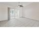 Bright living room featuring tile floors and sliding glass doors leading to a sunroom at 3712 3Rd W Ave, Palmetto, FL 34221