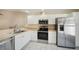 Modern kitchen featuring stainless steel appliances and white cabinetry at 3712 3Rd W Ave, Palmetto, FL 34221