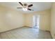 Bright bedroom with tile floors, ceiling fan and access to a hallway at 3712 3Rd W Ave, Palmetto, FL 34221