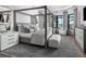 Main bedroom with a four poster bed, water views, and stylish furnishings at 1158 Blue Shell Loop, Sarasota, FL 34240