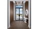 Elegant entryway with wood flooring, statement chandelier, and modern console table at 1158 Blue Shell Loop, Sarasota, FL 34240