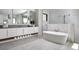 Spa-like bathroom with freestanding tub, double vanity, and modern fixtures at 1158 Blue Shell Loop, Sarasota, FL 34240