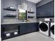 Laundry room with stylish cabinets and pet area at 1158 Blue Shell Loop, Sarasota, FL 34240