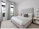Spacious bedroom with plush bed and large windows at 1158 Blue Shell Loop, Sarasota, FL 34240