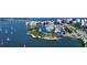 Breathtaking aerial view of a marina, waterfront condos, and a bridge over blue waters at 688 Golden Gate Point # 501, Sarasota, FL 34236