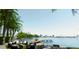 Waterfront patio offers stunning views with lounge seating, dining area, and dock access at 688 Golden Gate Point # 501, Sarasota, FL 34236