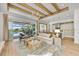 Open concept living room with kitchen and access to patio and pool at 11414 Brightly Dr, Venice, FL 34293