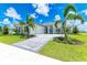 Luxury home exterior with stone accents and palm trees at 11414 Brightly Dr, Venice, FL 34293