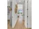 Light-filled hallway with hardwood floors, leading to a bedroom with water views at 11414 Brightly Dr, Venice, FL 34293