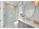Clean bathroom with walk-in shower and striped tile at 11414 Brightly Dr, Venice, FL 34293