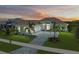 Two-story home with tile roof, stone accents, and landscaped yard at 11414 Brightly Dr, Venice, FL 34293