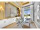 Bright home office features built-in shelves, a large window, and a glass desk at 11414 Brightly Dr, Venice, FL 34293