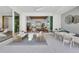 Relaxing outdoor patio with seating area, view into the great room, and modern decor at 11414 Brightly Dr, Venice, FL 34293