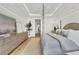 Main bedroom with large bed, dresser, and access to balcony at 11414 Brightly Dr, Venice, FL 34293