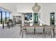 Covered patio with outdoor kitchen, dining table, and bar seating at 11414 Brightly Dr, Venice, FL 34293