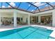 Stunning pool and patio area with covered lanai, outdoor kitchen, and dining area at 11414 Brightly Dr, Venice, FL 34293