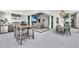 Outdoor kitchen with stainless steel appliances and bar seating at 11414 Brightly Dr, Venice, FL 34293