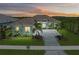 Stunning curb appeal with a paver driveway and tropical landscaping at 11414 Brightly Dr, Venice, FL 34293
