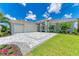 Luxury home exterior with stone accents and palm trees at 11414 Brightly Dr, Venice, FL 34293