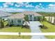 Coastal style home with tile roof, stone accents, and palm trees at 11414 Brightly Dr, Venice, FL 34293