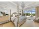 Main bedroom with a large bed, dresser, and access to a balcony at 11414 Brightly Dr, Venice, FL 34293