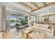 Living area with sliding doors opening to a pool and patio at 11414 Brightly Dr, Venice, FL 34293