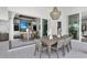 Enjoy this covered patio with a bar, dining area, and outdoor kitchen at 11414 Brightly Dr, Venice, FL 34293