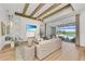 Living room with hardwood floors, comfortable seating, and sliding doors to the pool at 11414 Brightly Dr, Venice, FL 34293