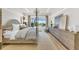 Spacious bedroom with a large bed, dresser, and access to a balcony at 11414 Brightly Dr, Venice, FL 34293