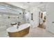 Bathroom with freestanding tub, shower, and marble tile at 11414 Brightly Dr, Venice, FL 34293