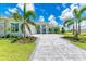 Luxury home exterior with stone accents and palm trees at 11414 Brightly Dr, Venice, FL 34293