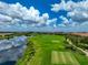 Golf course with pond, landscaping and residential buildings in the background at 13514 Messina Loop # 102, Bradenton, FL 34211