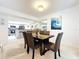 Bright dining room with dark wood table and six chairs at 3438 Wood Owl Cir # 273, Bradenton, FL 34210