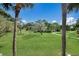Expansive community lawn with mature trees and a walking path at 3500 El Conquistador Pkwy # 339, Bradenton, FL 34210