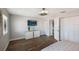 Bedroom with wood floors, large TV, and access to bathroom at 3500 El Conquistador Pkwy # 339, Bradenton, FL 34210