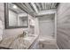 Modern bathroom with marble shower, wood-look walls, and updated vanity at 3500 El Conquistador Pkwy # 339, Bradenton, FL 34210