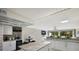 Open concept kitchen with breakfast bar and view to backyard at 3500 El Conquistador Pkwy # 339, Bradenton, FL 34210